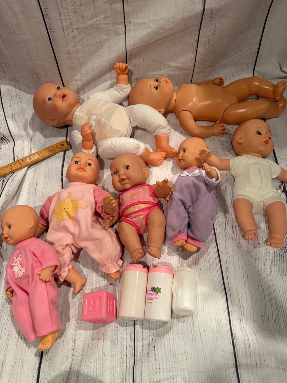 Lot of 7 Baby Dolls with a few accessories